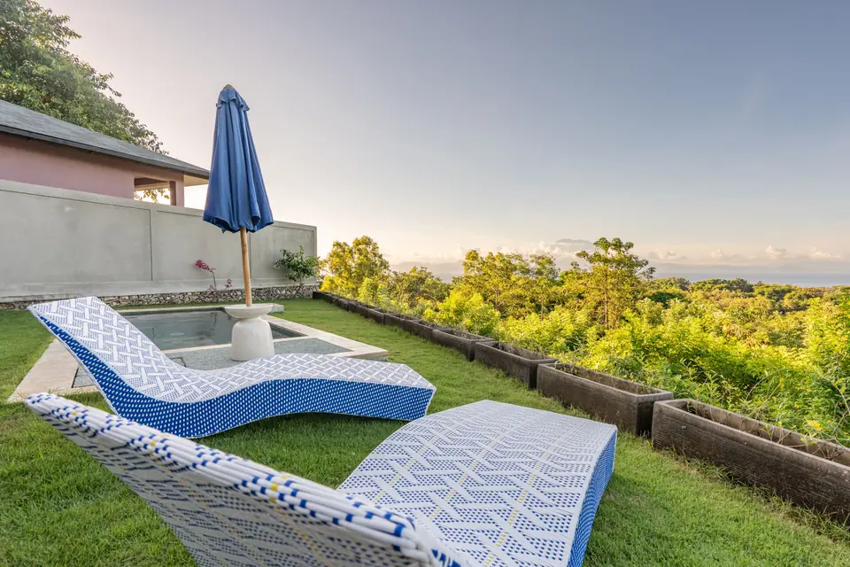 Sun loungers and parasol beside the Casa Azul pool