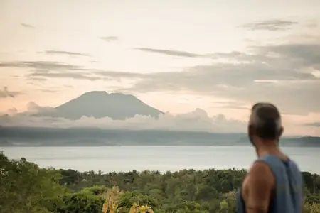 Guest looking across the Bali Sea to Mount Agung from Nusa Penida