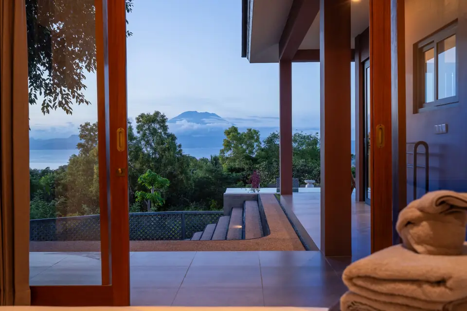Casa Om bedroom doors opening to the sea and Mount Agung